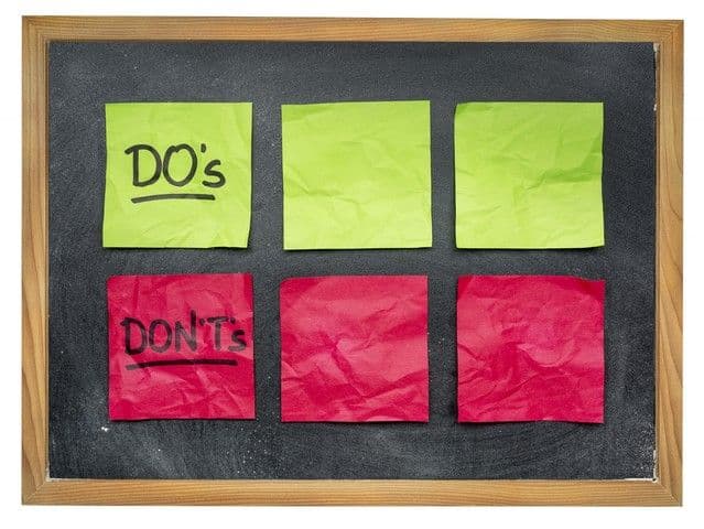 A chalkboard with six crumpled sticky notes, three green labeled "DO's" and three red labeled "DON'Ts," symbolizing guidelines.
