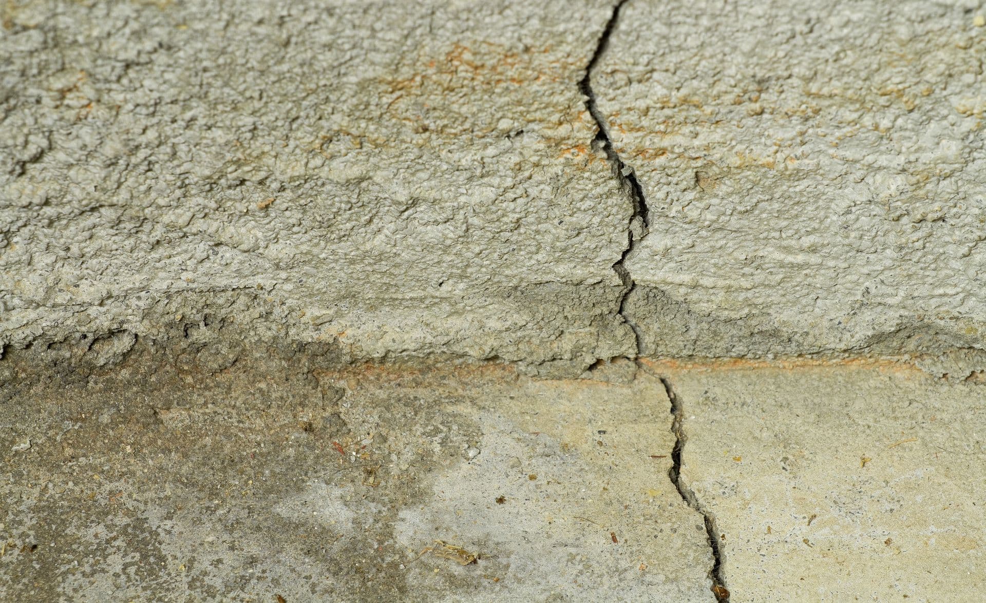 A crack in the concrete foundation of a residential house